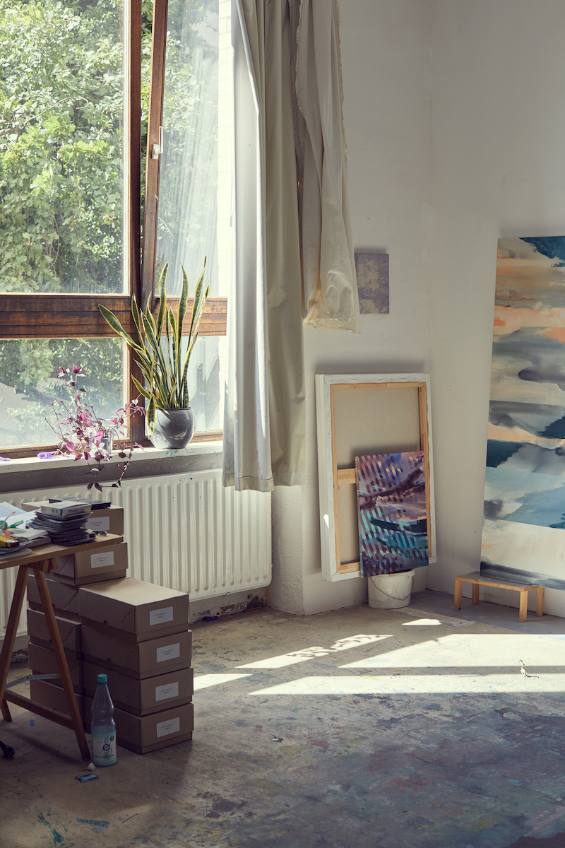 Photo by Martin Müller of Michelle Jezierski's artist studio, showing the window, part of a desk and paintings