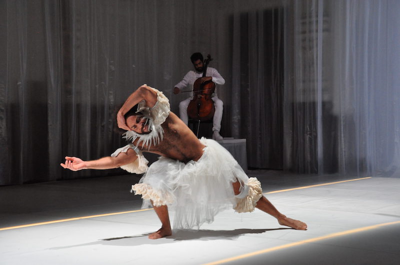 Two Black performers dancing on stage at Ballhaus Naunynstrasse in white costumes