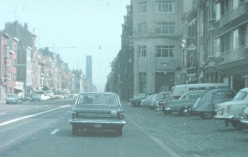 Berlin Art Link Interview with Sandra Heremans. Archival film still of a car driving down a city street in Belgium from the 1960s