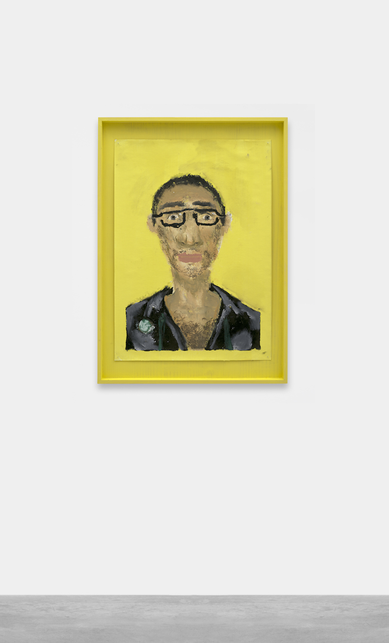 small painted portrait of a man with glasses on a yellow background, mounted on a white gallery wall