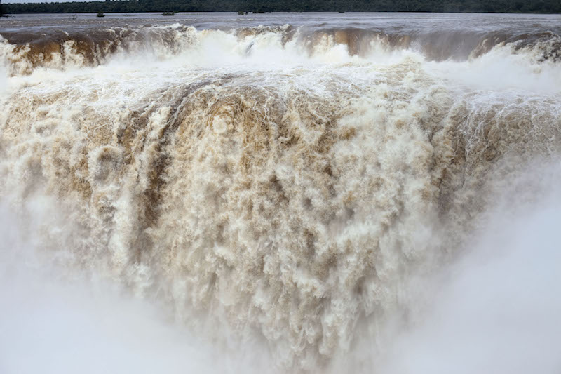 photograph of a fast moving and tumultuous looking waterfall, up close