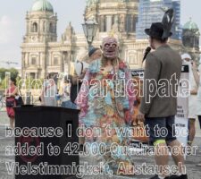 poster with photo of person in a colorful dress and zombie mask in front of Humboldt Forum, text reads 'I don't participate because I don't want to be added to 42,000 Quadrameter Vielstimmigkeit, Austausch und Diversität'