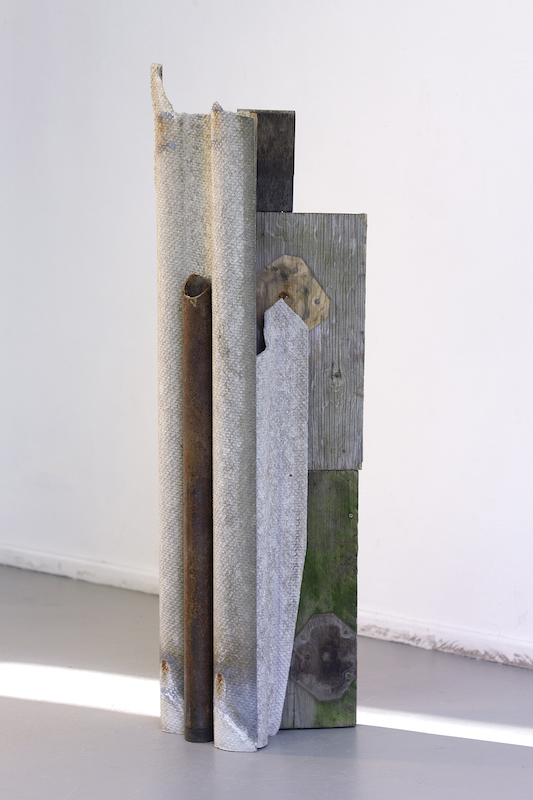 A photograph of De La Rubia's sculpture featuring concrete, steel and wood.