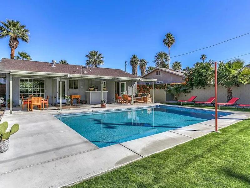 a photo of a swimming pool in the backyard of the bungalow in palm springs, california