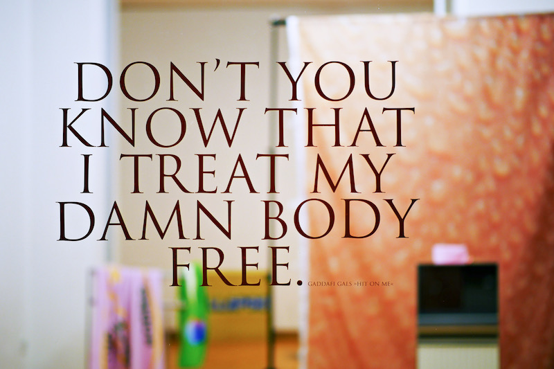 a close up photo of the gallery window, with text reading "Don't You Know That I Treat My Damn Body Free."