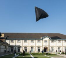 The black Aerocene Sculpture by Tomás Saraceno is floating in the sky above Maison Ruinart in Reims