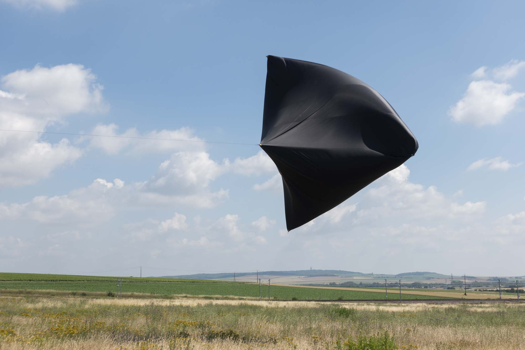 Aerocene Sculpture by Tomás Saraceno floating in the sky over the Ruinart vineyards in Champagne near Reims