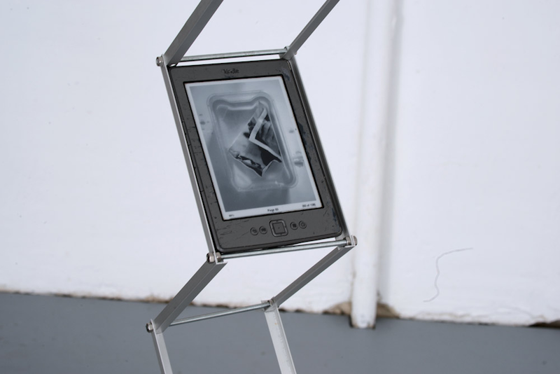 an e book reader mounted on a metal structure like a sculpture