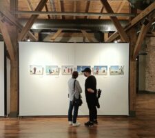 two people looking at photography in gallery