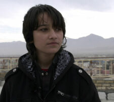 image of young afghan girl dress as boy