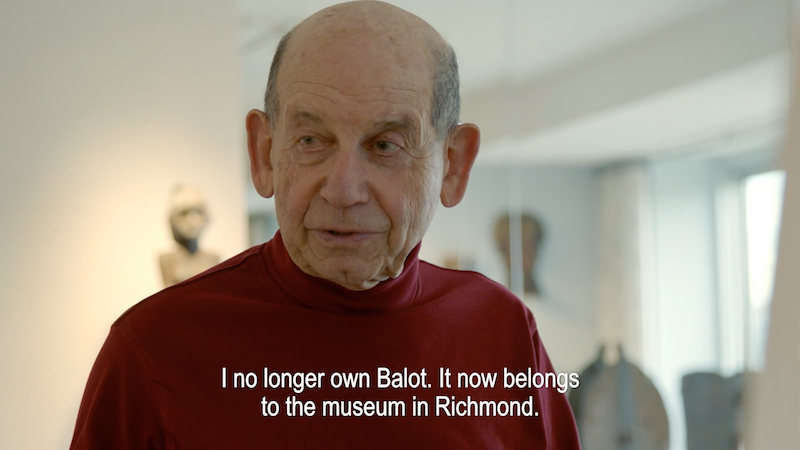 a close up still of the interview with Herbert Weiss with the subtitled text "I no longer own Balot, it now belongs to the museum in Richmond"