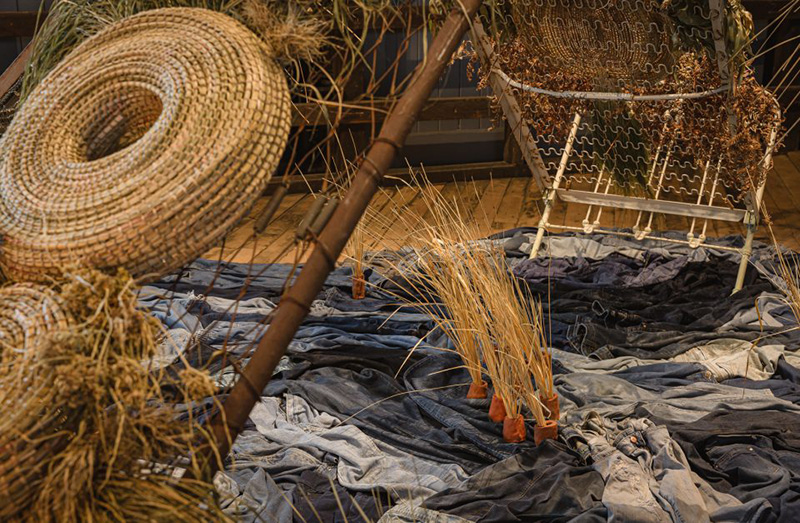 close-up of art work consisting of grass, cloth and household objects