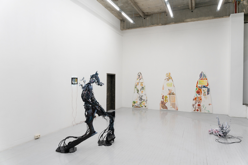 installation view of an exhibition with sculpture and painting