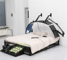image of a bed with computer monitors built around it