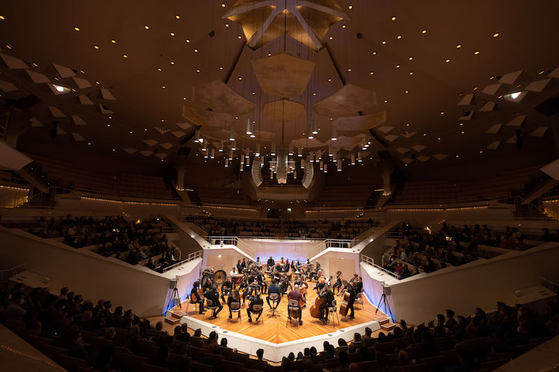 an aerial view of an orchestra playing on stage at the berliner philharmonie