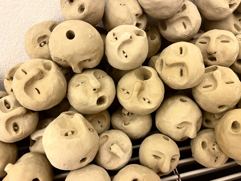 small beige ceramic heads in a pile