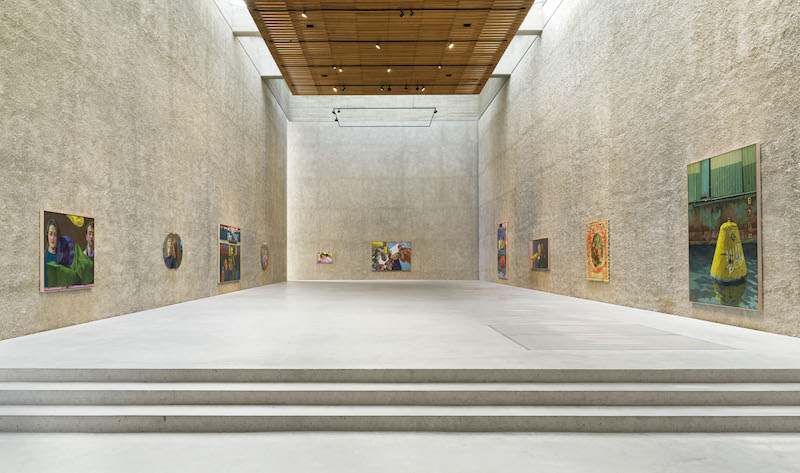 Photo of the upstairs hall at the König Galerie, lined with bright coloured paintings