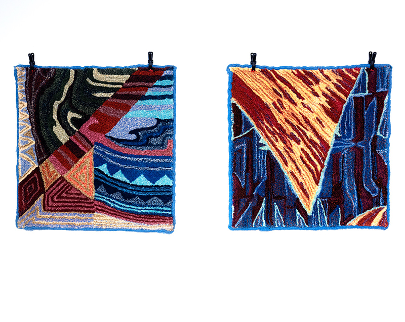 Two square rugs hanging on a wall