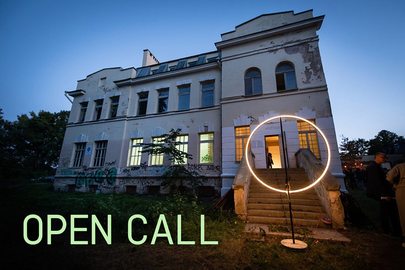 photo for an open call in lithuania, pictured is a villa at twilight with the words open call printed on top