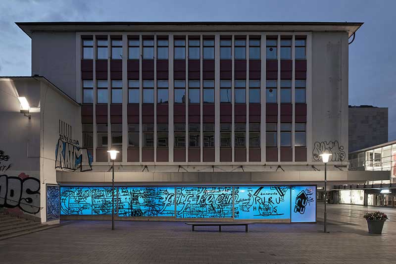 a photograph of a vacant department store with the ground level lit blue