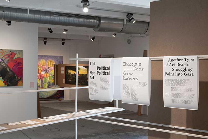 installation view of Question of Funding's installation for documenta fifteen. A gallery space with paitings and text can be seen