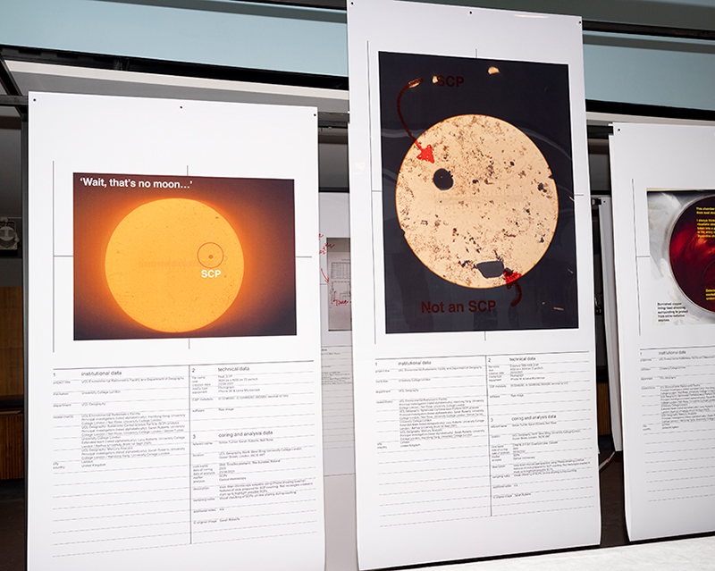 Large prints of the sun with explanatory texts suspended on metal scaffolding