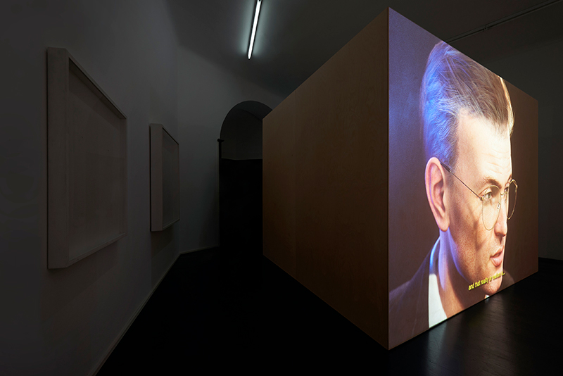 CGI animation of a man's head projected onto a large wooden box