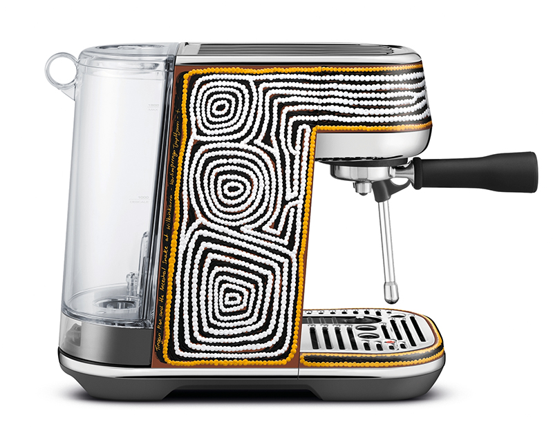 A promotional shot of a coffee machine seen from the side