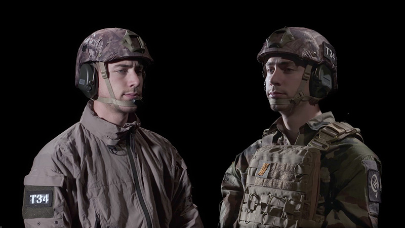A video still of two soldiers against a black background