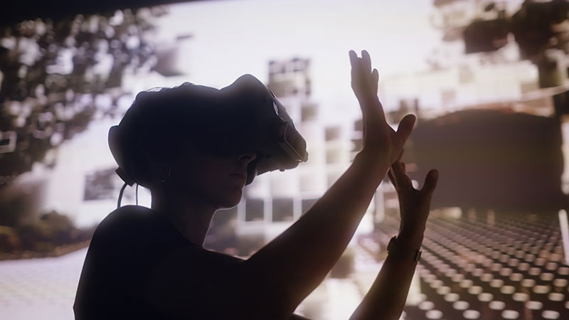 a photo of a person's silhouette wearing virtual reality goggles