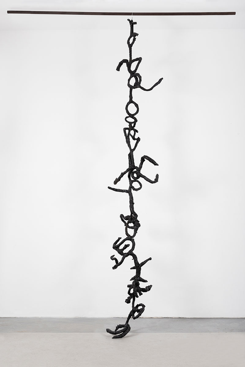 a photo of hanging sculpture consisting of abstract forms that look like letters
