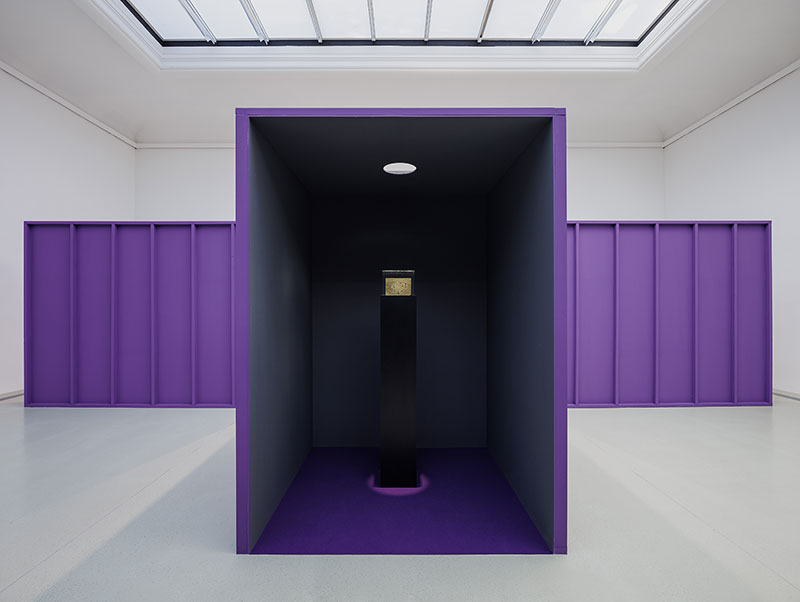 A photo of a gallery space with purple crate-like constructions in it
